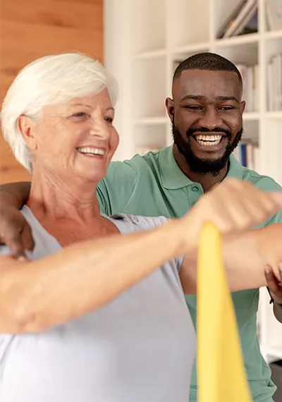Caregiver assisting senior exercise Caregiver assisting senior exercise